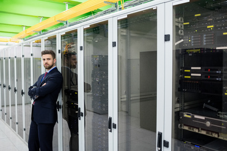 Portrait of technician standing with arms crossed in a server room