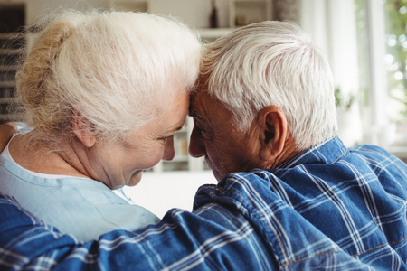 Senior couple embracing each other at homeの写真素材