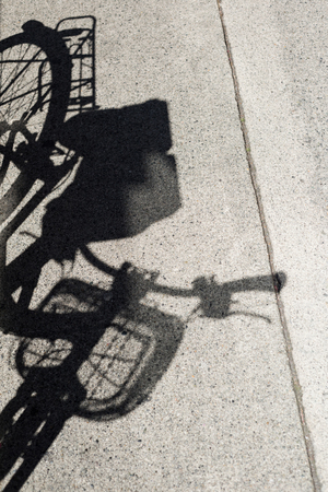 Shadow of cycle on a concrete road, backgroundsの写真素材