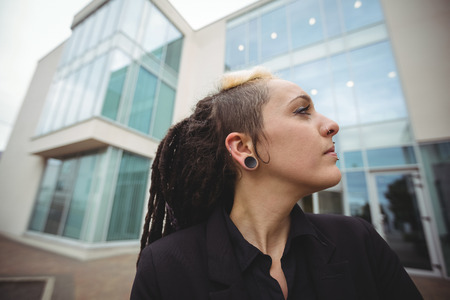 Close-up of businesswoman standing in office campus