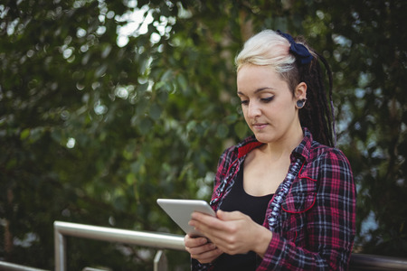 Woman using digital tablet in office campusの写真素材