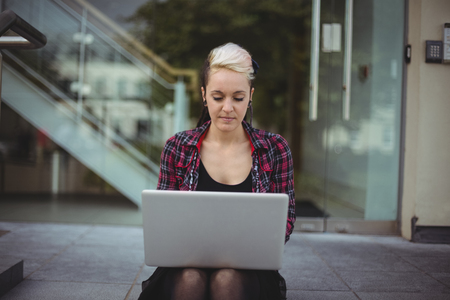 Woman using laptop in office campusの写真素材