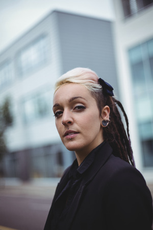 Portrait of confident businesswoman standing in office campus