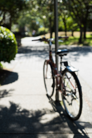 Blur view of bicycle parked in a park on a sunny dayの写真素材