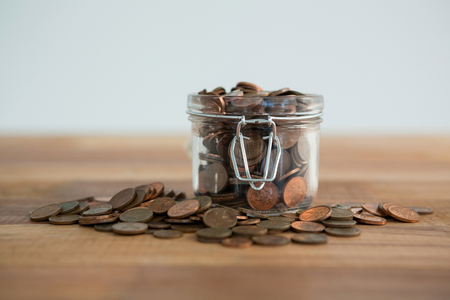 Close-up of coins in jar on table