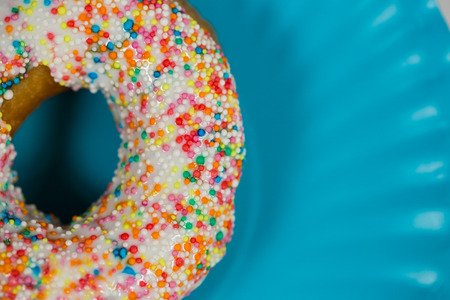 Close-up of tasty doughnuts with sprinkles on plate