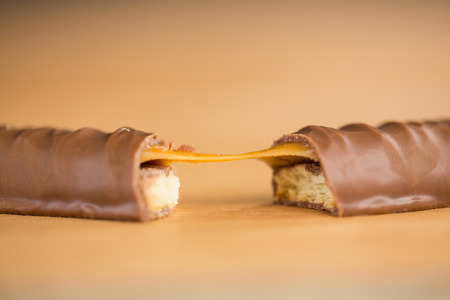 Close-up of chocolate and caramel bar on tableの写真素材