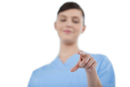Female doctor using digital screen against white backgroundの写真素材