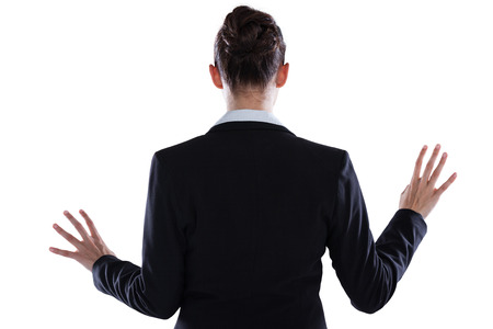 Rear view of businesswoman using digital screen against white backgroundの写真素材
