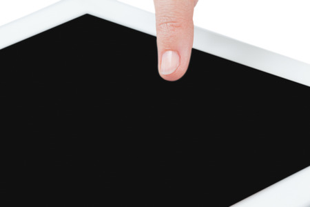 Close-up of hand using digital tablet against white backgroundの写真素材