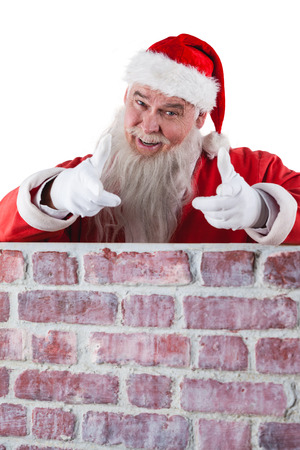 Portrait of smiling santa claus gesturing against white backgroundの写真素材