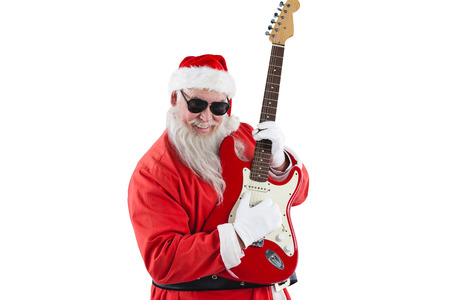 Smiling santa claus playing a guitar against white backgroundの写真素材