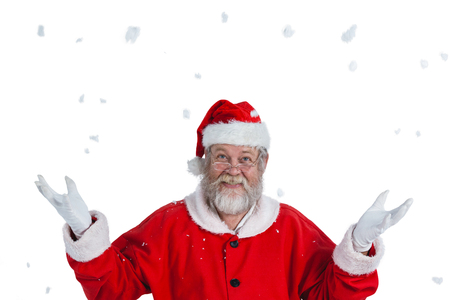 Portrait of smiling santa claus gesturing against white backgroundの写真素材