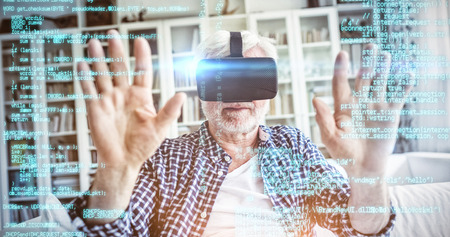 Blue programme against senior man wearing virtual reality headset in living room