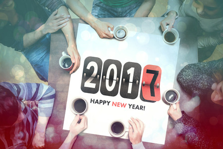 Digital composite of People drinking coffee around new year message