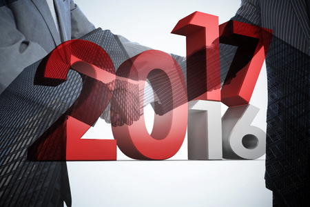 Digital image of new over old year against composite image of handshake in agreement