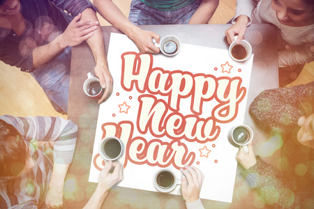 People drinking coffee around new year message