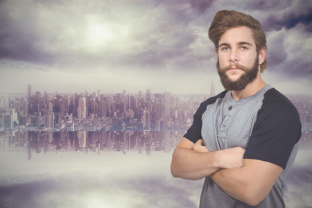 Portrait of confident hipster against room with large window looking on cityの写真素材