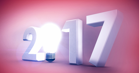2017 with glowing light bulb over white background against orange backgroundの写真素材