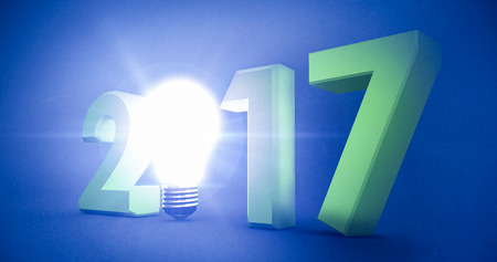 2017 with glowing light bulb over white background against blue backgroundの写真素材