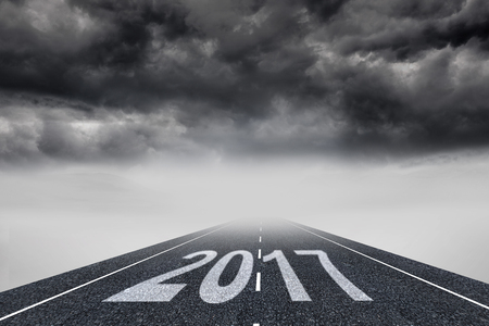 Happy New Year 2017 against stormy landscape background with streetの写真素材