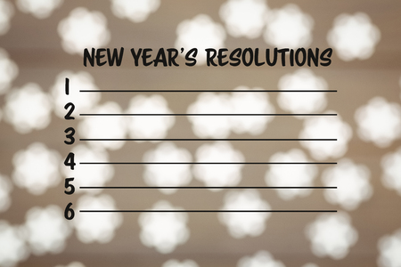 Composite image of new years resolution list and light ornament