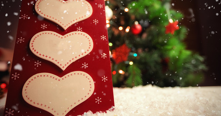 Snow falling against christmas label with massages with textの写真素材