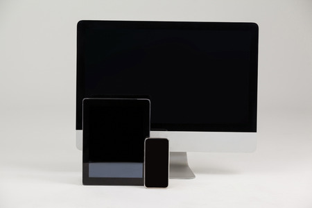 Close-up of computer, tablet and mobile phone on white backgroundの写真素材