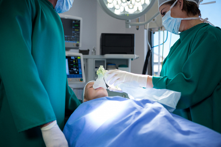 Surgeons operating patient in operation theater