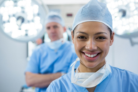 Portrait of female surgeon smiling in operation theaterの写真素材