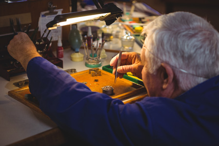 Horologist repairing a watch in the workshop