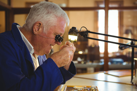 Attentive horologist working in workshop