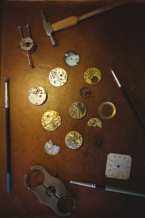 Horologists workshop with clock repairing tools on tableの写真素材