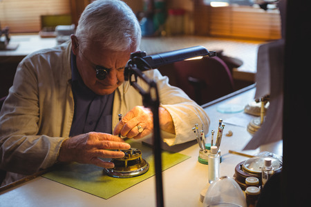 Horologist repairing a watch in the workshop