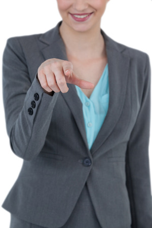 Businesswoman using digital screen against white backgroundの写真素材