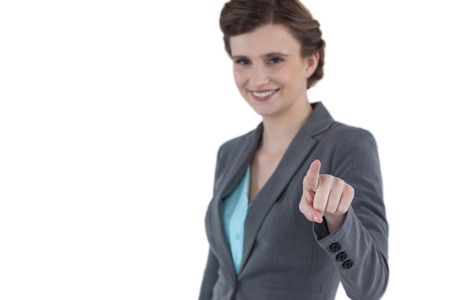 Portrait of businesswoman using digital screen against white backgroundの写真素材