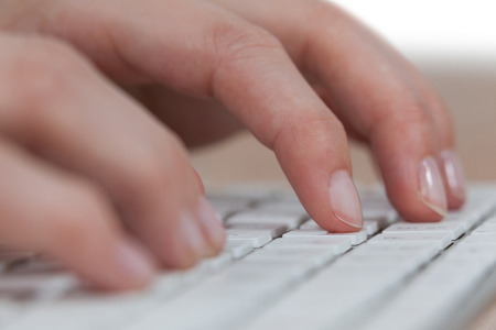Close-up of businesswoman typing on keyboard