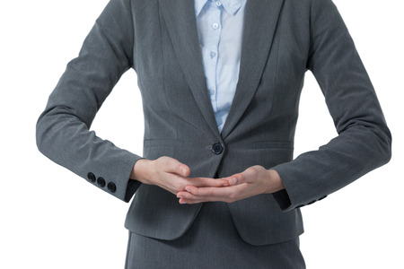 Mid section of businesswoman gesturing against white backgroundの写真素材
