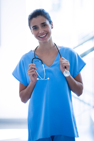 Female surgeon holding stethoscope at hospitalの写真素材