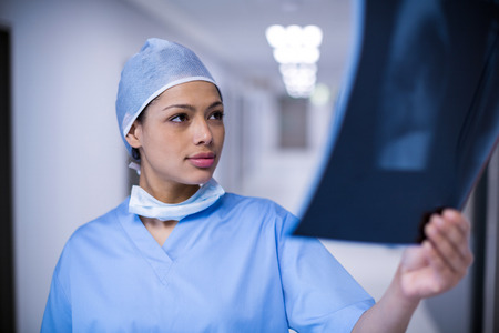 Female surgeon examining x-ray at hospitalの写真素材