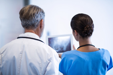 Doctor and nurse using digital tablet in hospitalの写真素材