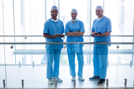 Portrait of surgeons standing in hospital corridor