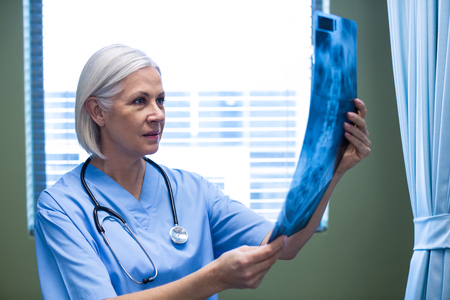 Nurse examining a x-ray in hospitalの写真素材