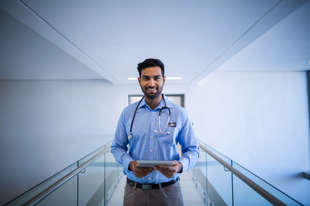 Portrait of doctor using digital tablet at the hospitalの写真素材