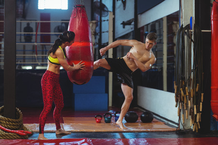Boxer practicing a kick boxing in fitness studioの写真素材