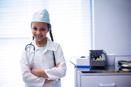 Portrait of smiling girl pretending to be a doctor in hospitalの写真素材