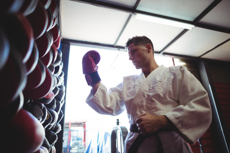 Kick boxer wearing gloves in fitness studioの写真素材