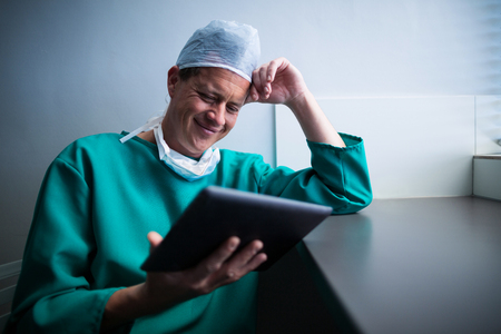Male surgeon using digital tablet of hospitalの写真素材