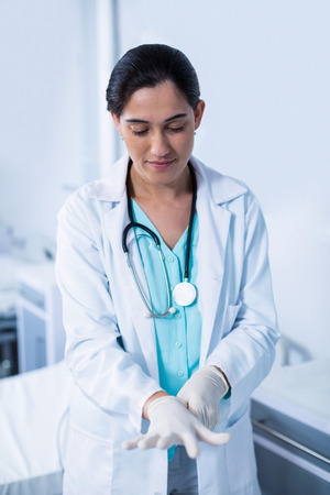 Beautiful doctor wearing gloves in hospitalの写真素材