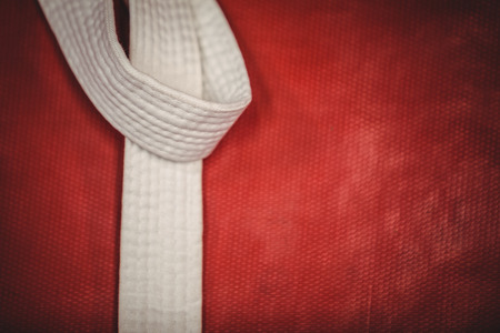 Close-up of karate white belt on red backgroundの写真素材